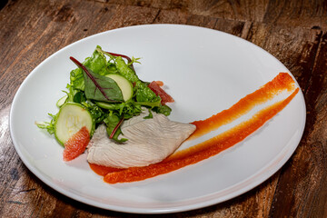 Roast chicken fillets and vegetables on gray background, close up