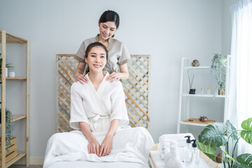 Asian young happy woman feeling relax during shoulder and back massage