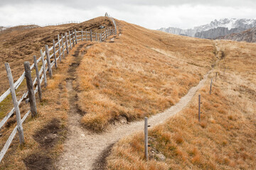 Wooden fence long a path in Val di Funes