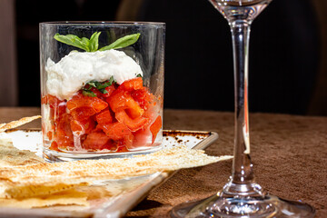 White soft cheese, feta, goat in bowl with tomatoes, parsley, olive oil
