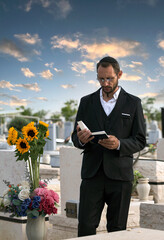 Bearded Jew in black kippah reading a Hebrew Bible, praying. Prayer in a jewish cemetery in Israel....