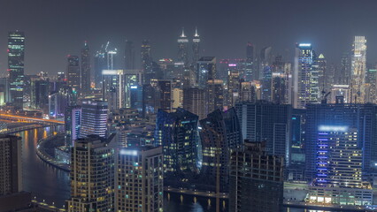 Obraz na płótnie Canvas Skyline with modern architecture of Dubai business bay towers night timelapse. Aerial view