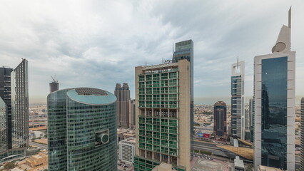 Fototapeta na wymiar Panorama showing Dubai international financial center skyscrapers with promenade on a gate avenue aerial timelapse.