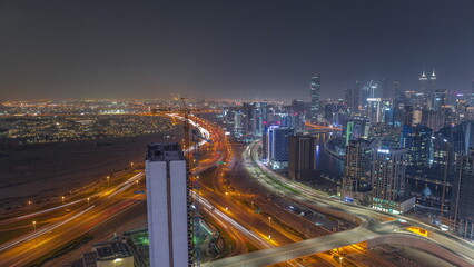 Fototapeta na wymiar Skyline with modern architecture of Dubai business bay towers night timelapse. Aerial view