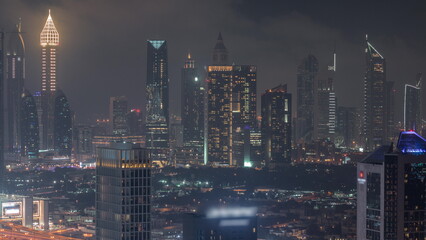 Rows of skyscrapers in financial district of Dubai aerial night timelapse.