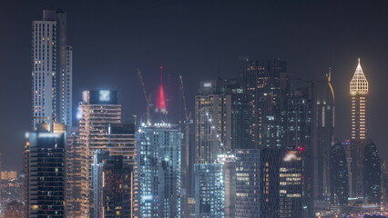 Fototapeta na wymiar Rows of skyscrapers in financial district of Dubai aerial night timelapse.