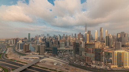 Naklejka na ściany i meble Panoramic skyline of Dubai with business bay and downtown district morning timelapse.