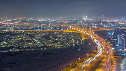 Fototapeta na wymiar Aerial view of Al Khail road busy traffic near business bay district night timelapse