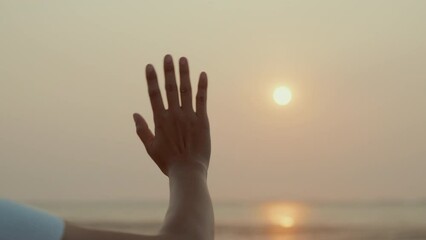 Woman waving hand say goodbye or parting with sunset alone on the seaside, Time to go farewell