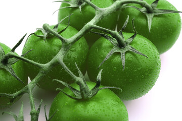Fresh green cherry tomatoes on white background, closeup