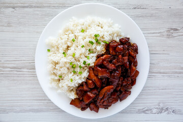 Homemade Teriyaki Chicken with White Rice on a Plate on a white wooden background, top view. Flat lay, overhead, from above.