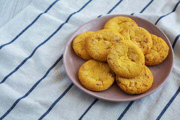 Homemade Lemon and White Chocolate Cookies on a Plate on a white wooden background, low angle view. Copy space.