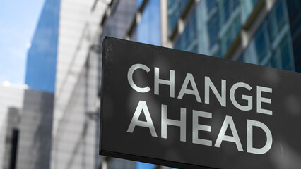 Change Ahead on a black city-center sign in front of a modern office building	
