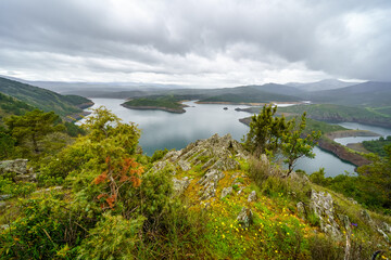 Panoramic of a valley with lakes between the mountains and cloudy stormy day.