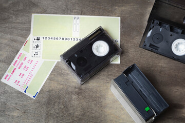Mini videotapes for the video camera of the 90s. Stickers-plates for marking, placing information on the cassette case. Top view, flatlay, retro concept.