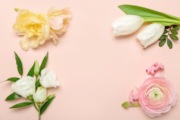 Frame made of different flowers on pink background
