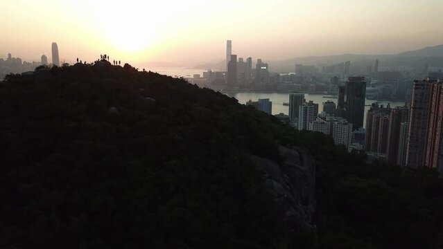 Hong Kong Victoria Harbour sunset with hiker on the mountion
