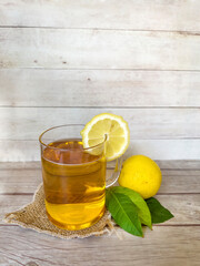 Kombucha tea with lemon in glass cup 