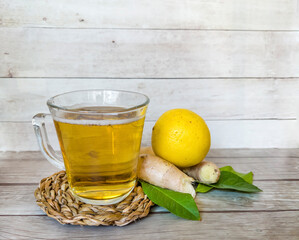 Kombucha tea with lemon and ginger  in glass cup 