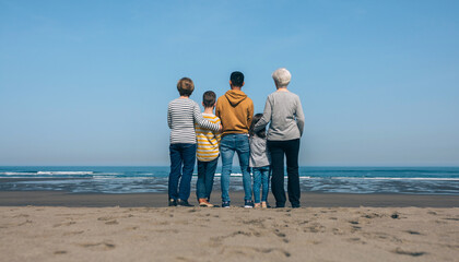 Unrecognizable group of multiethnic people in the beach backwards watching the sea
