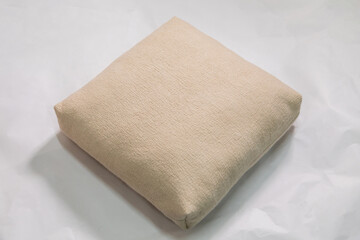 Handmade milky felt pillow on a white background