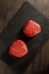 raw filet mignon on a cutting board
