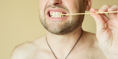bearded man holding a toothpick