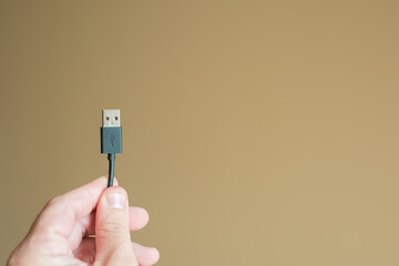 black usb cord in hand