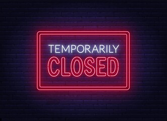 Temporarily closed neon sign on brick wall background.
