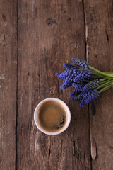 Obraz na płótnie Canvas Bouquet of small blue Muscari flowers and coffee