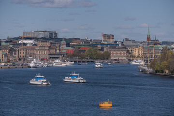 View over the bay Str&ouml;mmen with commuting boats and skyline of the old town Gamla Stan, tower buildings and churches a sunny spring day in Stockholm