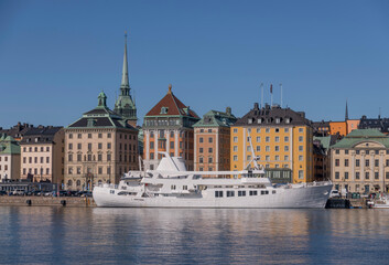 Fototapeta na wymiar Panorama skyline over the old town Gamla Stan with roof church tower and boats a sunny spring day in Stockholm