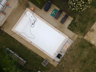 Drone flight over pool in the middle of greenery just left out and cleaned