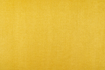 Background of orange suede fabric closeup. Velvet matt texture of orange nubuck textile