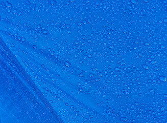 Water drops on waterproof membrane fabric. Morning dew on tent.