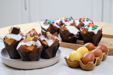 Easter cakes with chocolate ornaments and painted eggs on the table in the home kitchen