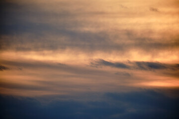 Evening dramatic sky with beige clouds during sunset