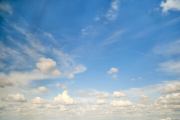 Fototapeta premium White cumulus clouds in the blue sky. Bright beautiful sky, copy space background
