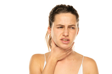 Young woman with throat pain on a white background