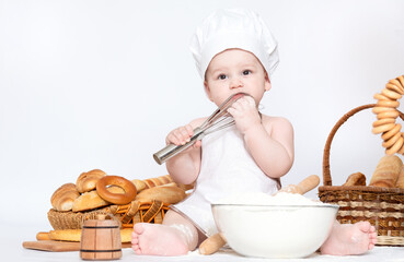 Little boy in a cook cap and with bread funny little chef