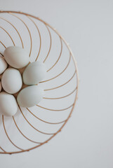 white chicken eggs. eggs in the basket. white eggs on a white background