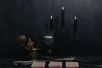 Mystic still life with voodoo doll, the tarot cards, books, evil candles and witchcraft objects....