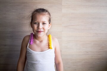 a girl plays with rubber tracks and they crawl over her shoulders