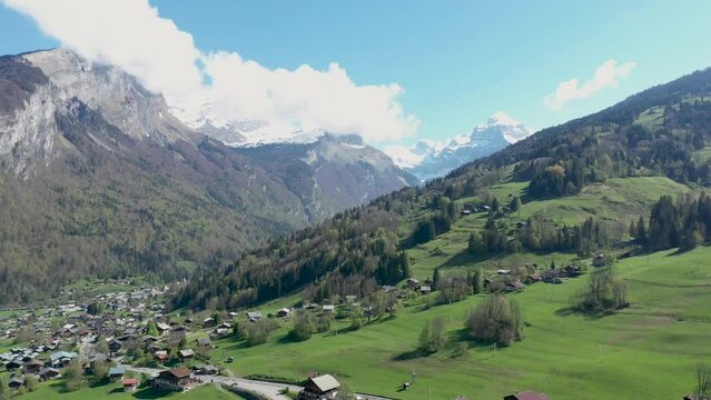 Stunning drone footage of Alpine Mountains, forests and waterfalls. Chalets nestle in the beautiful landscape near Sixt fer Cheval in the French alps.