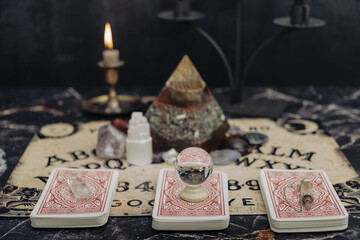 Mystic ritual with Ouija and candles. Devil's board concept, black magic or fortune telling rite with occult and esoteric symbols. Mystical rituals and occult sciences.