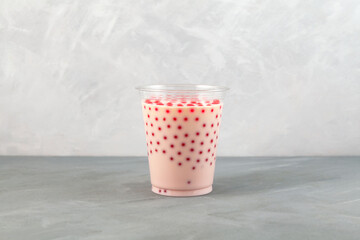 Strawberry Bubble tea (also known as bubble milk tea) in disposable plastic cup. Is a tea-based drink with chewy tapioca balls