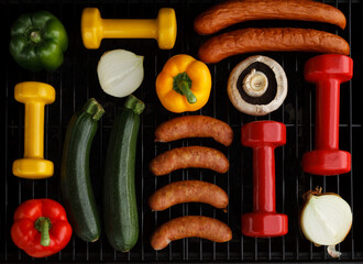 Heavy dumbbells with bell peppers, onions, mushroom and sausages on a grill. Fit barbecue party...