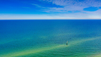 Blue sea water and blue sky in a sunny day. - obrazy, fototapety, plakaty