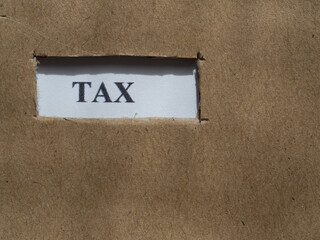 Tax word on cardboard cutout with copy space