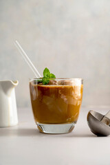 Affogato coffee, coffee and chocolate ice cream in glass on bright background